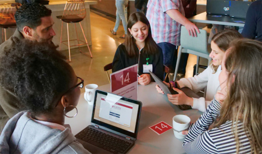 Student group talking with laptops and ipad devices